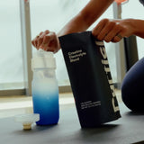 creatine electrolyte blend package with a water bottle in the background.